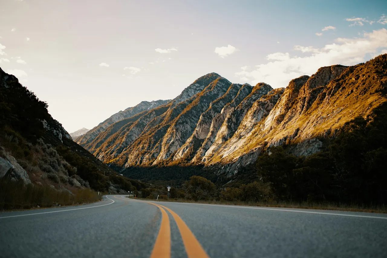 A winding road through sunlit mountains near Salt Lake City, Utah